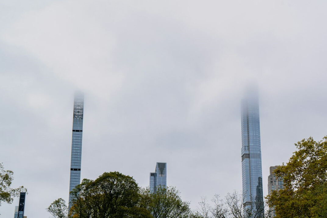 Industrial factory with smoke stacks against a grey sky