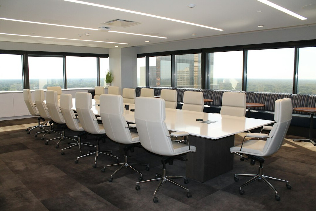 Empty corporate boardroom with a long table and chairs