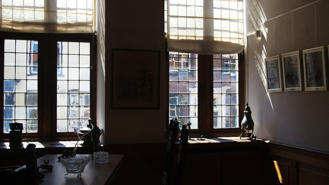 Small independent newsroom office with desks and windows